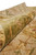Rolled edge close-up showing olive green border pile depth and cotton foundation of the handmade rug