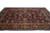 8' x 11'2" Indian hand-knotted rug shown at an angle, plum field, navy floral border