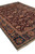 Corner perspective of handmade Indian wool rug showing cream fringe, indigo border and palmette motifs