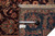 Tape measure and inventory tag on back of hand-knotted wool rug showing knot density
