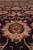 Macro of burgundy field motif in salmon, teal and rust showing knots per square inch