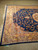 Corner of the bamboo silk rug with ivory fringe, navy selvage and lustrous golden border