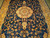Overhead detail of golden medallion, turquoise accents and dense floral vinework on midnight blue