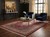 Dark paneled living room with navy velvet chairs and gold table over red Mahi rug