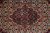Macro shot of medallion center with slate blue rosettes, ivory diamonds and small red flowerheads