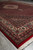 Angled floor view of new hand knotted 6'6" x 10'1" Mahi rug in deep red