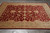 8' x 10'1" hand-knotted wool Oriental rug displayed on grey tile floor, angled view