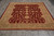 8 x 10 Peshawar Chobi wool rug shown full length on grey tile with ivory fringe