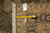 Tape measure and inventory tag confirming 7'11" x 9'10" size against the golden border