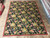 Full 9 x 12 Chinese needlepoint rug shown from above on the showroom stone floor
