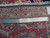 Back of the rug with ruler beside knots confirming authentic handmade wool weave and cotton foundation