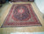 9'3 x 13'1 Kashan rug laid flat on light wood floor showing full navy field