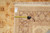 Tape measure and hand-woven oriental rug tag laid across the border for scale