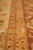 Close-up where gold guard stripes of vinework meet the brown main border band