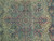 Close-up of the rose and indigo floral medallion drawn on the pale celadon green field