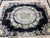 Close overhead of the oval medallion with pink roses and blue peonies on ivory ground