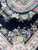Field detail showing flower garland swags, open black ground and the inner ivory guard border