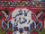 Woven signature cartouche in Persian script, ivory ground with navy lettering, on this signed Kashmar rug