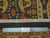 Measuring ruler across the ivory fringe end confirming authentic hand knotted wool construction and tight weave