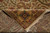 Back of the wool rug folded over the pile showing dense even knotting and fringe