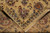 Folded corner revealing the tight hand-knotted back, even knotting and fringe of this Indian rug