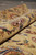 Rolled edge showing plush pile depth, burgundy floral detailing and the closely clipped wool surface