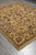 8x10 Jaipur Oriental rug shown in full on grey tile, traditional gold all-over floral