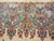 Close-up of the rose and turquoise Lavar Kerman border with scrolling acanthus palmettes above ivory field