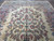 Angled view showing the central floral cluster and honeyed patina of this 1940s Persian rug