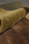 Rolled edge showing pile depth and the soft wool surface against a deep brown field