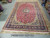 10'9" x 16'7" oversize Persian rug laid flat on warehouse floor showing complete allover floral design