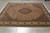 8'1" x 10' wool and silk area rug photographed on a grey tile showroom floor