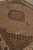 Diagonal view of the beige field, corner pendant motifs and olive green guard stripes