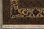 Corner detail of the ivory main border with rust palmettes, olive vines and zigzag guard stripes