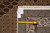 Tape measure and dealer tag confirming the 8'1" x 10' size beside the woven border