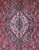 Close-up of the ivory and navy lobed medallion at the center of this hand-knotted Persian rug