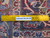 Reverse side with ruler confirming authentic handmade knotting across this 10x13 Persian Kashan rug
