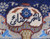 Woven signature cartouche in ivory on the navy field of this signed Persian Kashmar wool rug