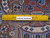 Ruler on the back showing the fine hand-knotted weave density of this Persian Kashmar rug