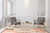Oversize Moroccan rug grounding a bright living room with grey lounge chairs and gold coffee table