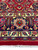 Navy main border and twin ivory guard borders with hand-tied cotton fringe along the end
