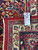 9'7" x 12'8" Persian rug reverse side with dealer tag showing rug number and size