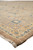 Low angle along the edge of the Peshawar rug showing dense clipped pile and blue flower heads