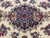 Detail of the navy blue central medallion with red roses, green leaves and ivory palmettes