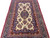 5x7 hand-knotted wool rug seen from the end, ivory ground covered in rose flower sprays