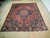 10'2" x 12'5" Bakhtiari rug displayed flat on light hardwood floor showing full medallion layout