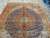 Wool pile sheen visible across the navy field of this 8 x 12 Persian Tabriz rug