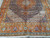 Angled view showing dense Herati lattice, ivory spandrels and multiple guard borders in rust and gold