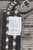 Back label listing size 14'2" x 9'9", hand-knotted in Pakistan, 100% natural wool