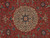 Close-up of ivory and navy star medallion framed by red field and cream rosettes